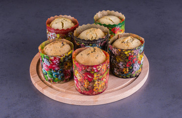 six easter cakes on a round wooden stand