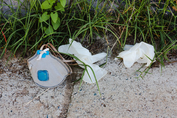 Surgical masks and gloves discarded on the street. Waste disposal problem in coronavirus times,...