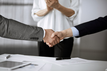 Obraz na płótnie Canvas Business people shaking hands finishing contract signing, close-up. Business communication concept. Handshake and marketing