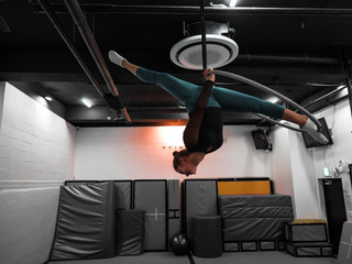 Sport woman making a split in training circus room