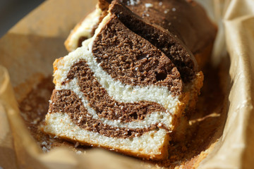 Marble cake in baking paper close-up.
