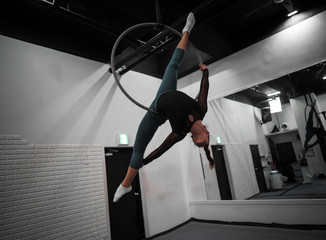 Aerial artist female in training gym