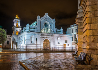 Cuenca, Ecuador, November 2013: The Sanctuary church (El Sagrario) facade and side views, at night time, after a rainy afternoon.