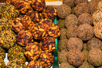 Turkish fruit and nut candy. Scattered pistachio and almond nuts.