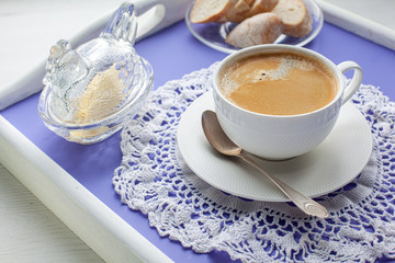 Breakfast served on lavender bed tray, butter dish,  bread