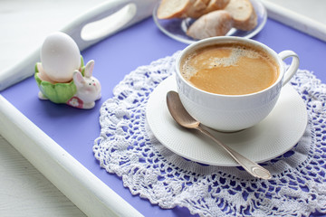 Breakfast served on lavender bed tray with coffee, egg, bread