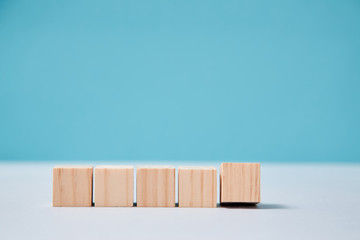 Empty wooden cubes mockup for creative inscription design. Blank blocks in line template on blue...