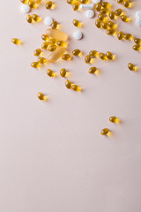 Natural vitamins and supplements on pink background