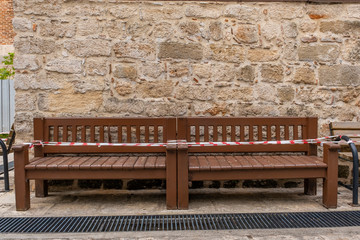 Bench in front of brick wall no sitting for virus