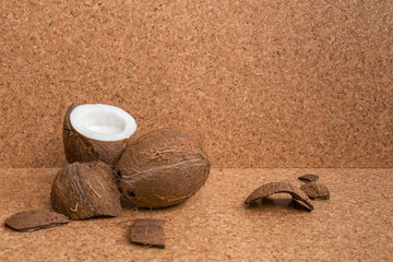 Fototapeta na wymiar Top view of coconut milk and coconut are on wooden background, cork background. Coconut vegan milk lactose free. Copy space. Healthy drink concept.