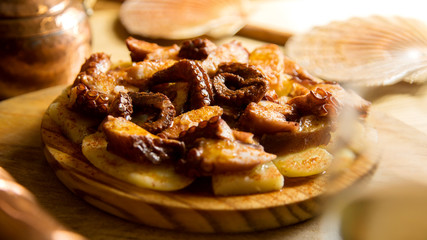 Traditional spanish Pulpo a la gallega. Boiled octopus served with bell pepper, salt, potatoes and olive oil.