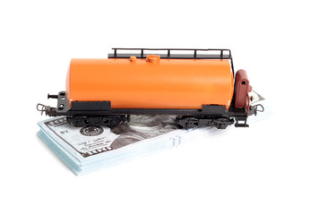 Oil tank and paper dollars on a white background