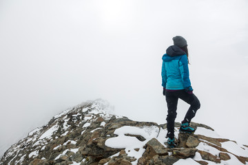 An alpinist girl on the high mountain ridge in the French Alps, Chamonix Mont-Blanc, France. Scenic...