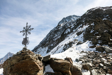 Haute-Savoie cross and stones near the Grand Couloir of Mont-blanc massif in the French Alps,...