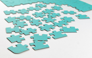 not fully assembled puzzle in blue on a light background