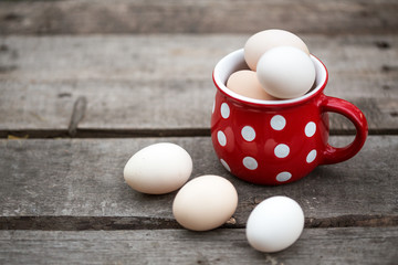 chicken eggs in a big red cup