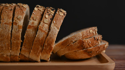 Close up. Slice whole grain bread on the wooden table.