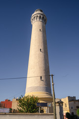 fortress with a lighthouse on the coast of the Atlantic ocean in North Africa against the blue sky