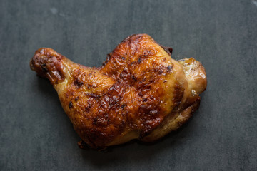 Grilled chicken fillets on black slate plate serve on concrete background