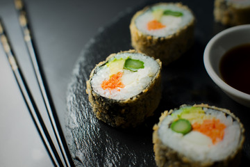 Vegetarian fried sushi roll with asparagus, carrot, cream cheese, daikon and avocado. 
