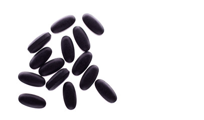 Black pills on a white background with empty space for text