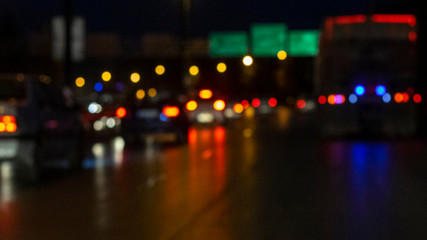 Traffic jam on a city road at night. Abstract defocused car headlights. Night highway background.