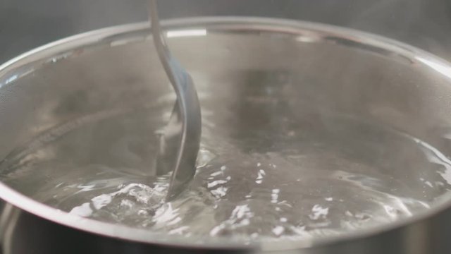 Slow Motion Stirring Water To Dissolve Salt In Pot