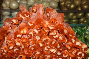 Cevizli sucuk made by dipping a string with walnuts into a grape molasses mixture