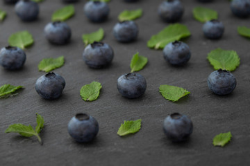 Blueberry with mint seamless pattern on concrete background close up. 