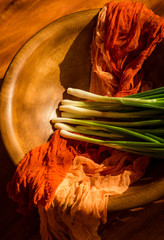 
green onions on a brown background