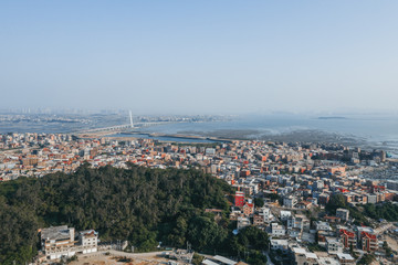 Fototapeta premium Aerial view of a Chinese traditional fishing village around Xiamen city, with residential buildings and fishing boats