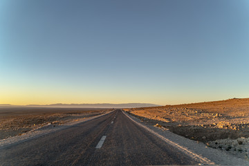 Fototapeta na wymiar road at dawn in the Sahara desert in North Africa