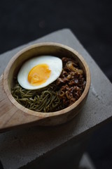 Green Noodle in a Wooden Bowl