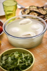 buffalo mozzarella in the center and in the background the ingredients for the Mediterranean diet...