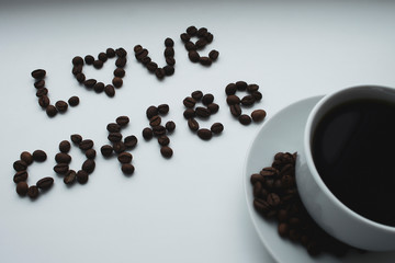 Cup of black coffee on white surface, 