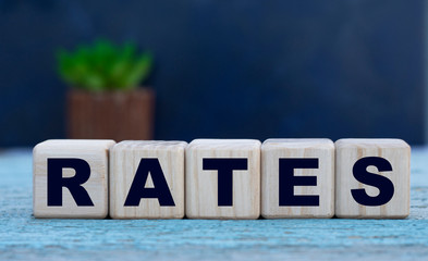 RATES the word on cubes on a background of old gray background with cactus