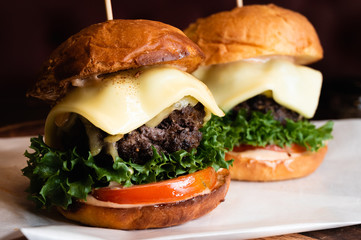 Two beef burgers with cheese