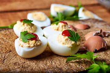 close-up of some hard-boiled stuffed eggs on a rustic table