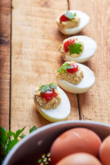 close-up of some hard-boiled stuffed eggs on a rustic table