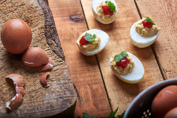 close-up of some hard-boiled stuffed eggs on a rustic table