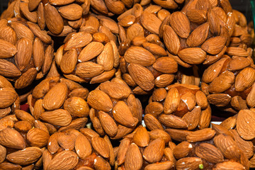 Turkish fruit and nut balls candy. Scattered pistachio and almond nuts