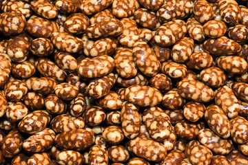 Chocolate covered glazed nuts and seeds, full frame, isolated background