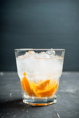 Old fashioned beverage with orange slices on rustic background. Selective focus. Shallow depth of field.