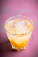 Old fashioned beverage with orange slices on rustic background. Selective focus. Shallow depth of field.