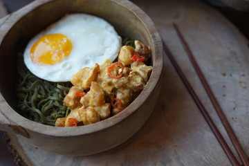 Green Noodle in a Wooden Bowl