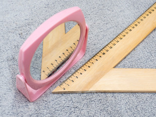 wooden triangle with scale isolated on gray background