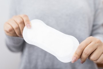 Close-up Showing pictures of women holding sanitary pads in different postures

