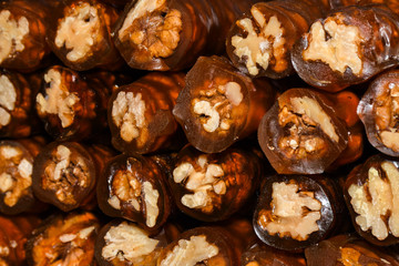 Cevizli sucuk made by dipping a string with walnuts into a grape molasses mixture
