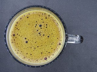The foam of coffee in the glass cup    