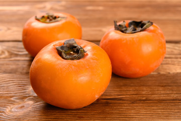 fresh persimmons on a wood table